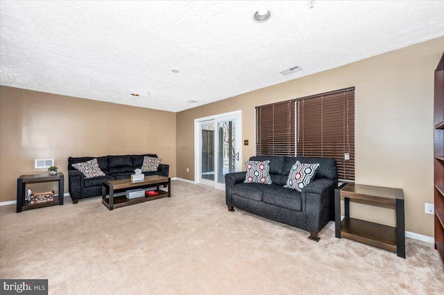 living room with light colored carpet and a textured ceiling