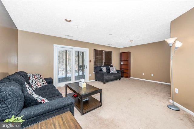 living room featuring light colored carpet and a textured ceiling