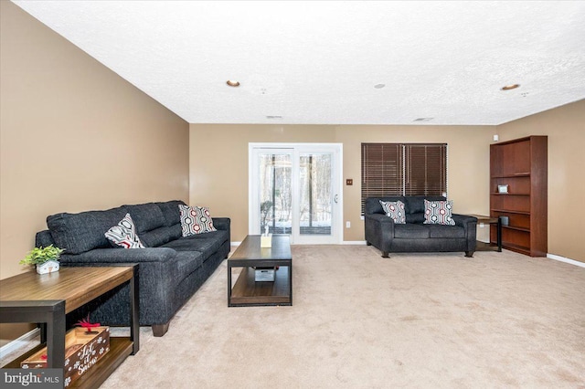 living room with light carpet and a textured ceiling