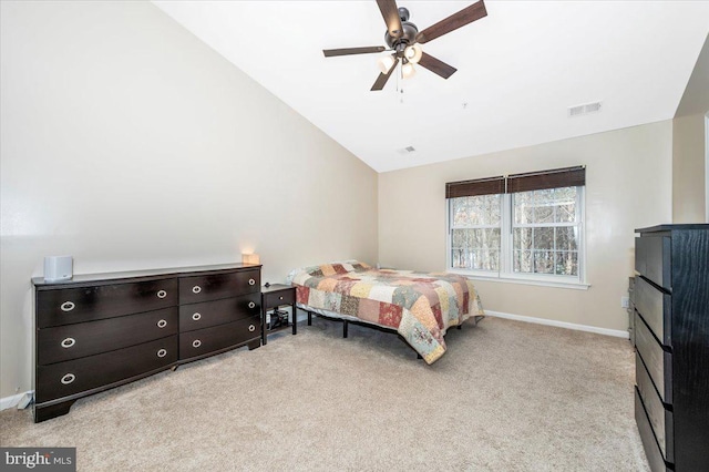 bedroom with vaulted ceiling, light colored carpet, and ceiling fan