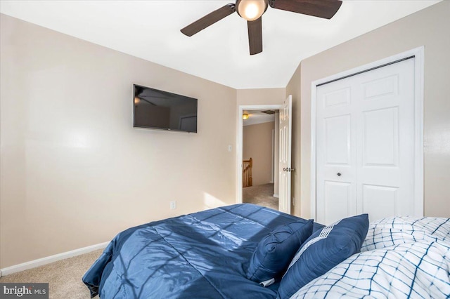 carpeted bedroom featuring a closet and ceiling fan