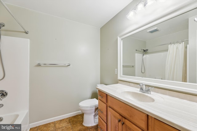 full bathroom with vanity, shower / tub combo, and toilet