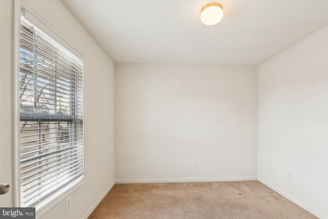 carpeted spare room with plenty of natural light