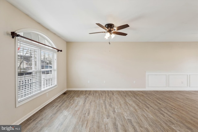 spare room featuring hardwood / wood-style floors and ceiling fan