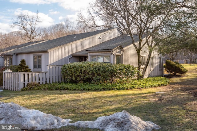 view of side of home featuring a lawn