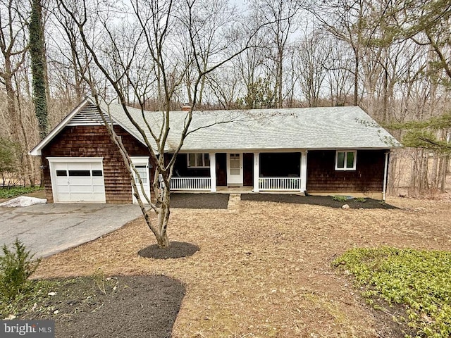 ranch-style house featuring a porch and a garage