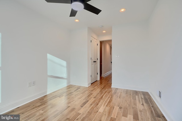 spare room featuring ceiling fan and light wood-type flooring