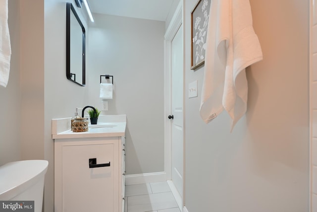 bathroom with tile patterned flooring, vanity, and toilet