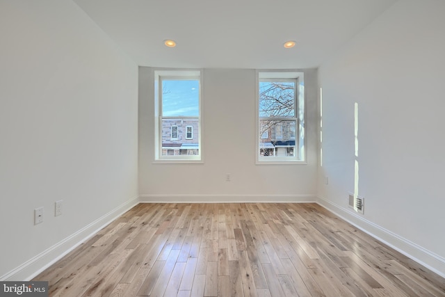 unfurnished room with light wood-type flooring