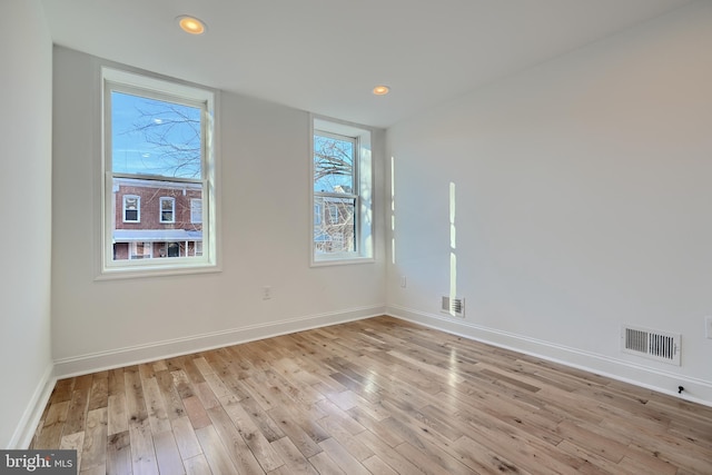 spare room featuring light hardwood / wood-style floors