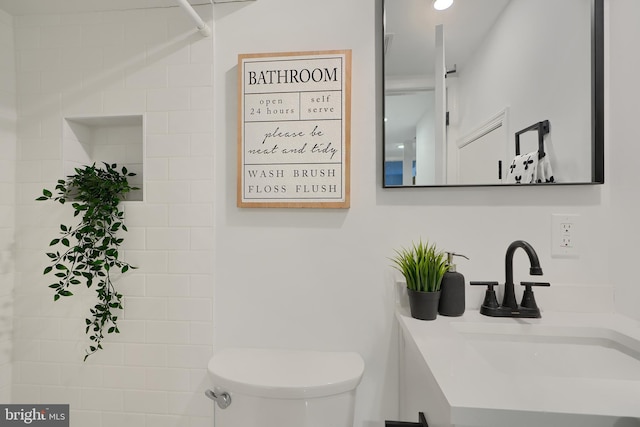 bathroom featuring vanity and toilet