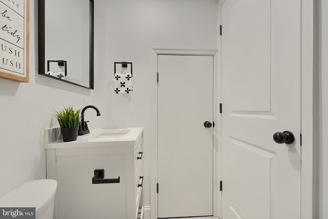 bathroom featuring vanity and toilet