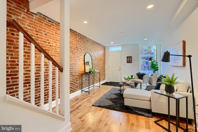 entryway featuring light hardwood / wood-style floors and brick wall