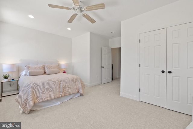 carpeted bedroom featuring a closet and ceiling fan