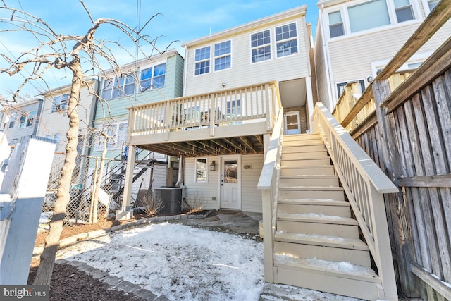 rear view of property with central air condition unit and a wooden deck