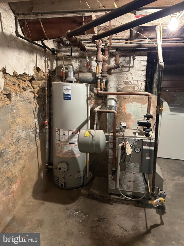 utility room featuring water heater and washer / clothes dryer