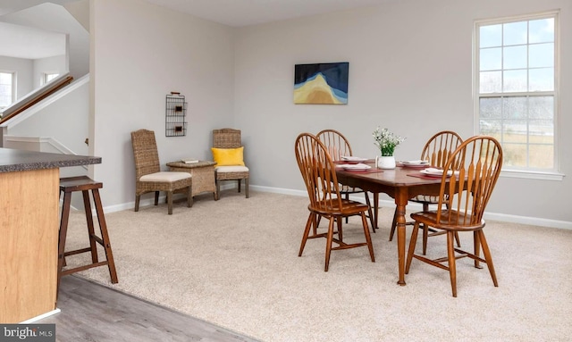 carpeted dining area featuring plenty of natural light