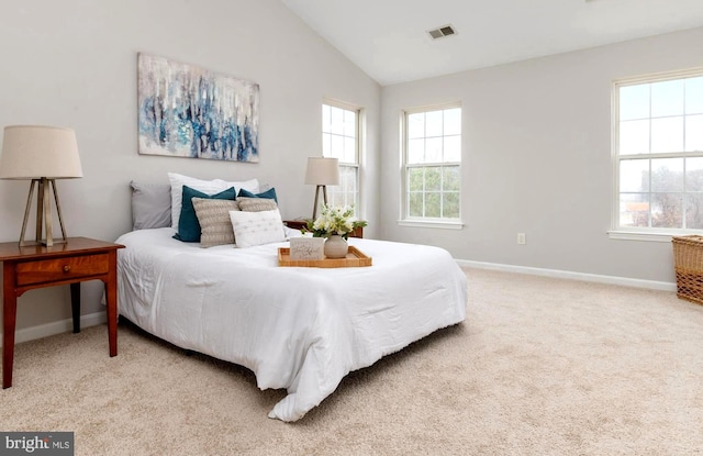 bedroom featuring vaulted ceiling and light colored carpet