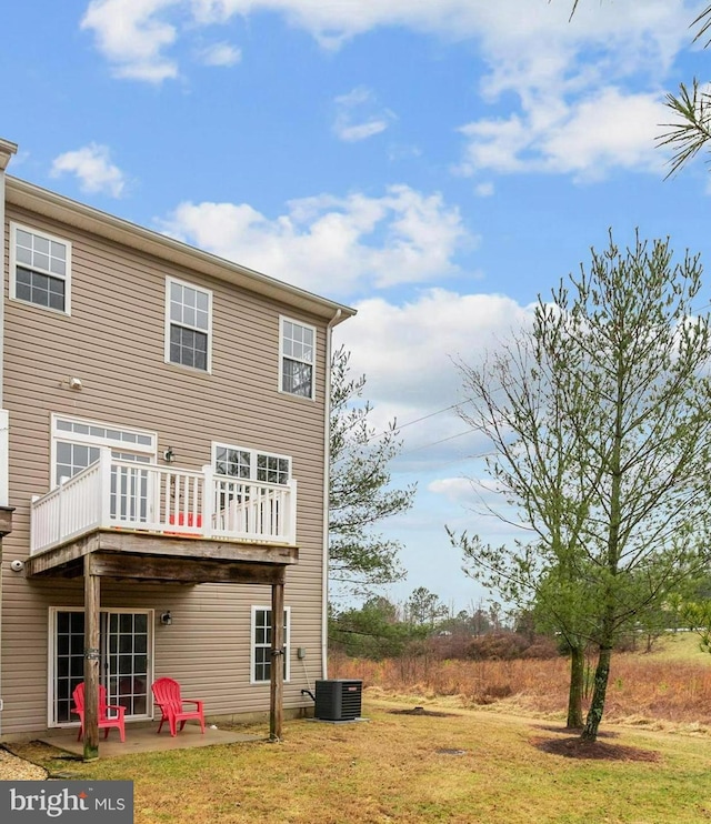 rear view of house with central AC unit, a patio area, a lawn, and a deck