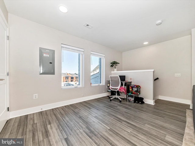 office space with hardwood / wood-style floors and electric panel