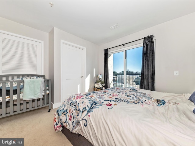 carpeted bedroom featuring access to outside