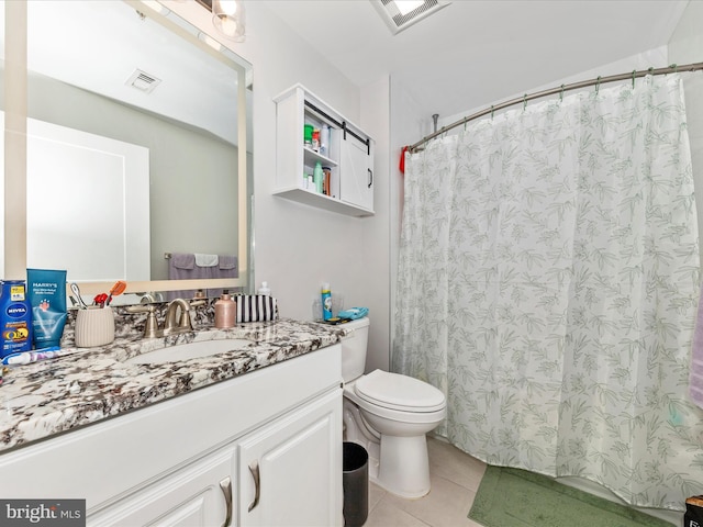 bathroom featuring toilet, tile patterned floors, and vanity