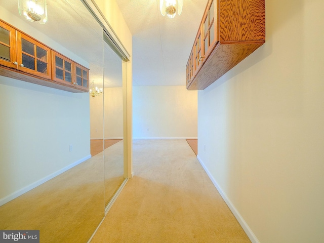 hallway featuring light carpet