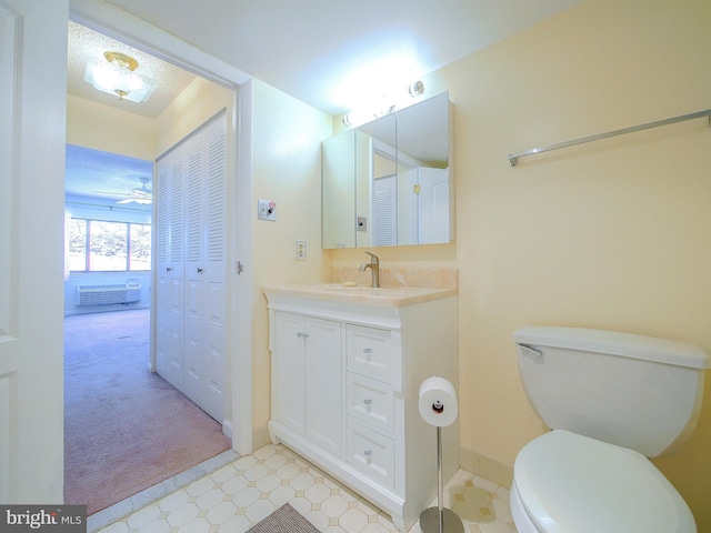 bathroom with ceiling fan, toilet, and vanity