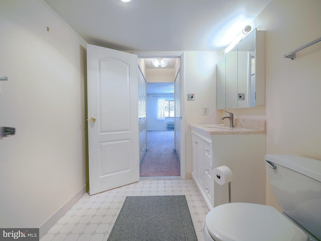 bathroom featuring toilet and vanity