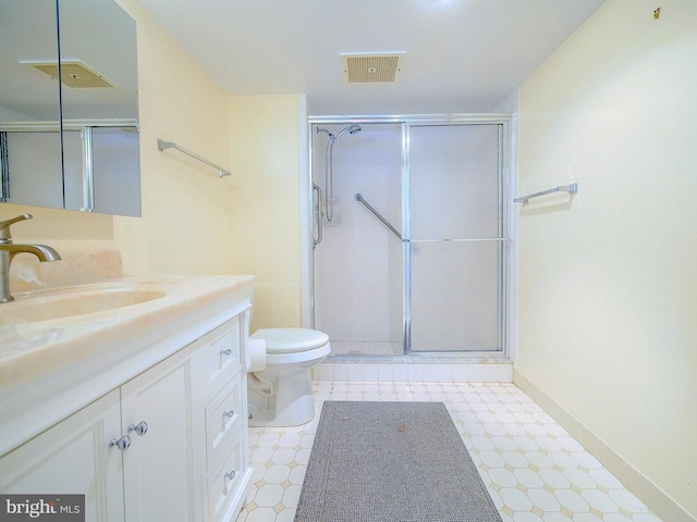 bathroom with a shower with door, toilet, and vanity