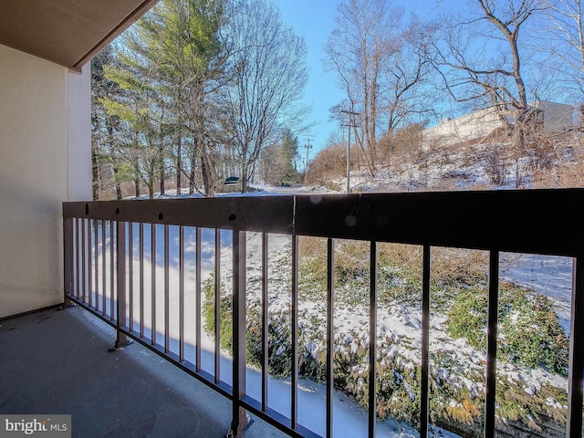 view of snow covered back of property