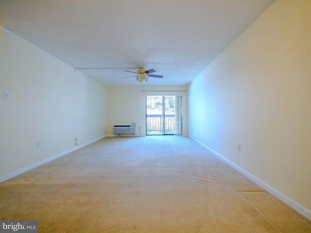 unfurnished room featuring ceiling fan, light colored carpet, and a textured ceiling