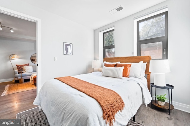 bedroom with hardwood / wood-style flooring