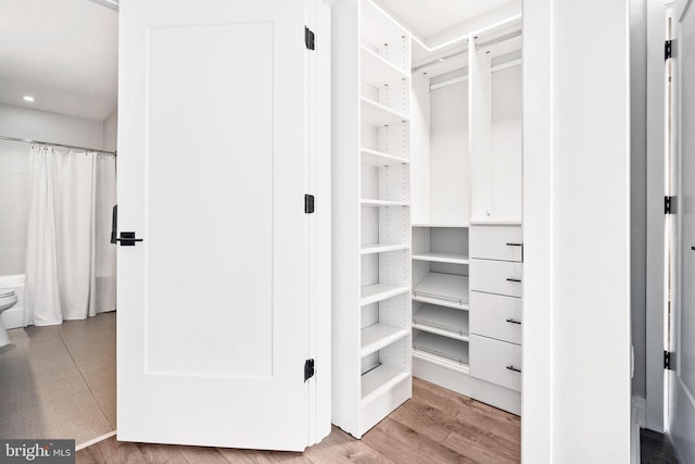 spacious closet with light hardwood / wood-style floors