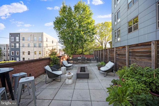 view of patio featuring an outdoor living space with a fire pit