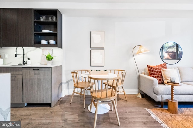 dining space featuring sink and light hardwood / wood-style floors