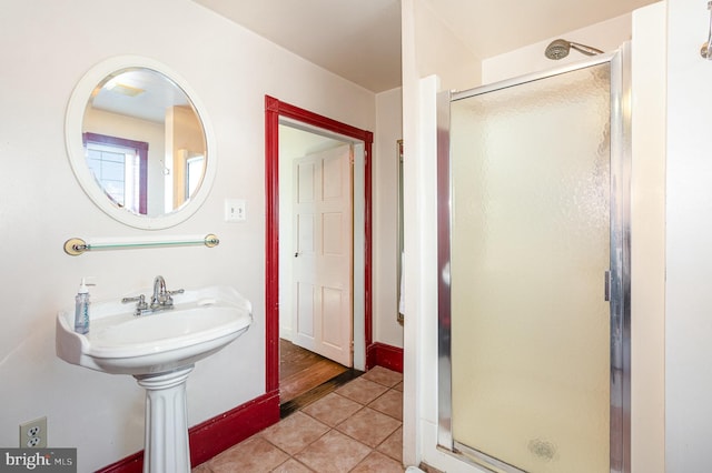 bathroom featuring a shower with door and tile patterned floors