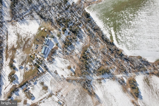 snowy aerial view with a water view