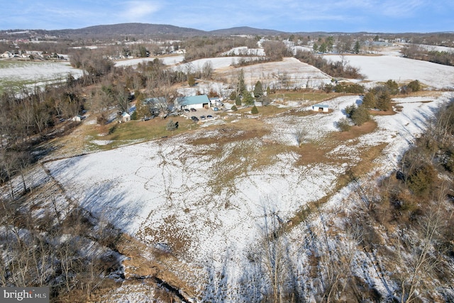 snowy aerial view featuring a mountain view