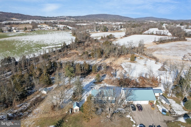 snowy aerial view featuring a mountain view