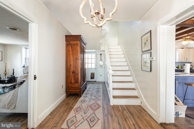 foyer featuring an inviting chandelier and dark hardwood / wood-style floors