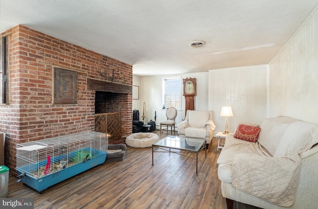 living room featuring hardwood / wood-style flooring and a fireplace