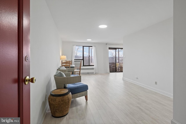 living area with radiator and light hardwood / wood-style floors