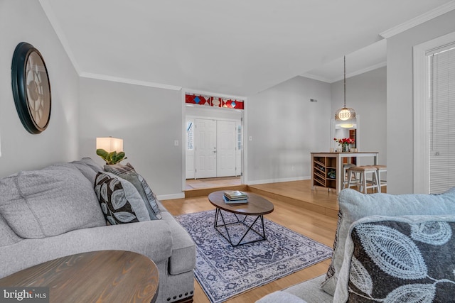 living room with wood-type flooring and crown molding