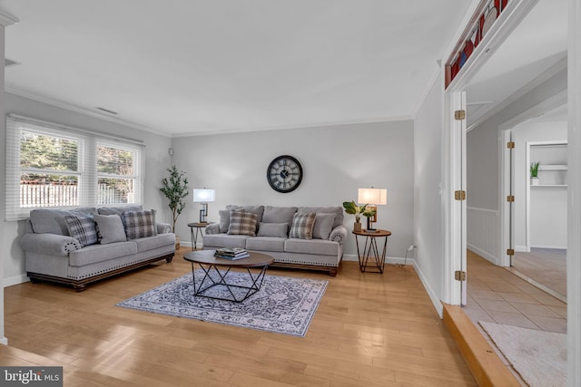 living room featuring crown molding and light wood-type flooring