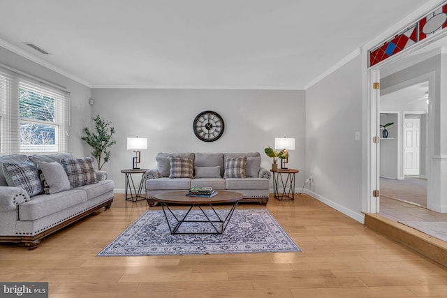 living room featuring light hardwood / wood-style flooring and ornamental molding