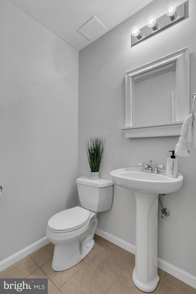 bathroom with sink, tile patterned floors, and toilet