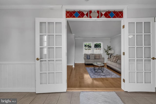 living room with ornamental molding and tile patterned floors