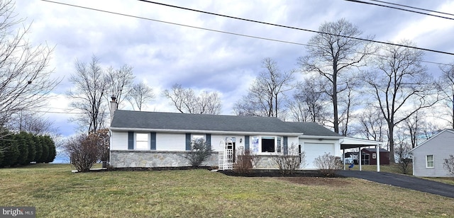 single story home with a garage, a front lawn, and a carport