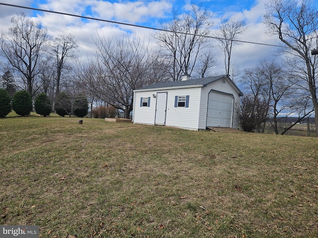 view of outdoor structure with a garage and a yard